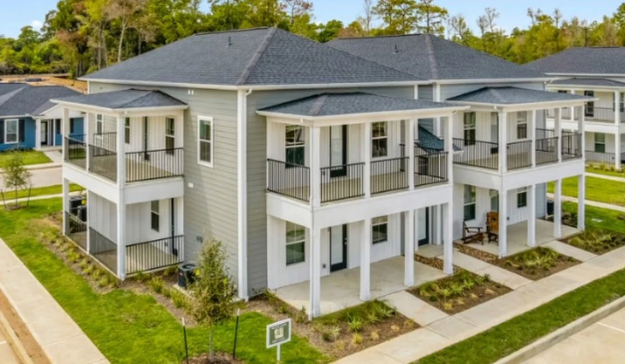 Modern two-story duplexes with covered balconies in suburban Conroe Texas residential neighborhood