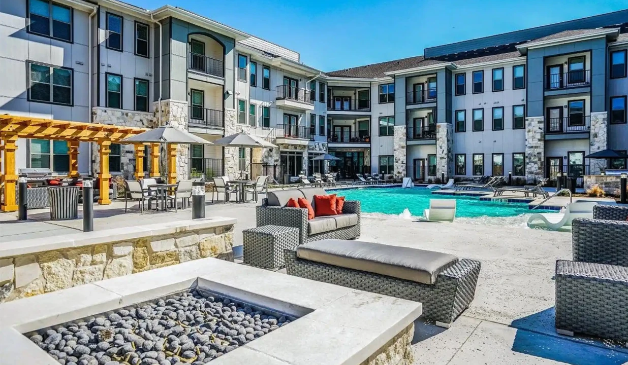 Resort-style apartment community with outdoor pool, fire pit, and modern lounge seating