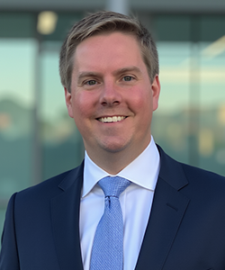 Headshot of Travis Bloodgood, Director
